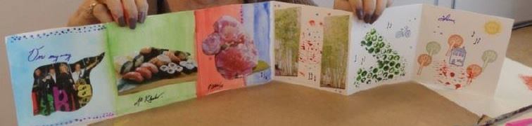 Close up view of a visual arts project created by a patient at Bridgepoint. The work is a fold out booklet with different panels, each with a different painting, drawing or image on it. 