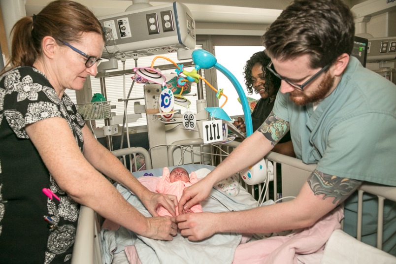 Nurses examining the skin of a patient for pressure injuries