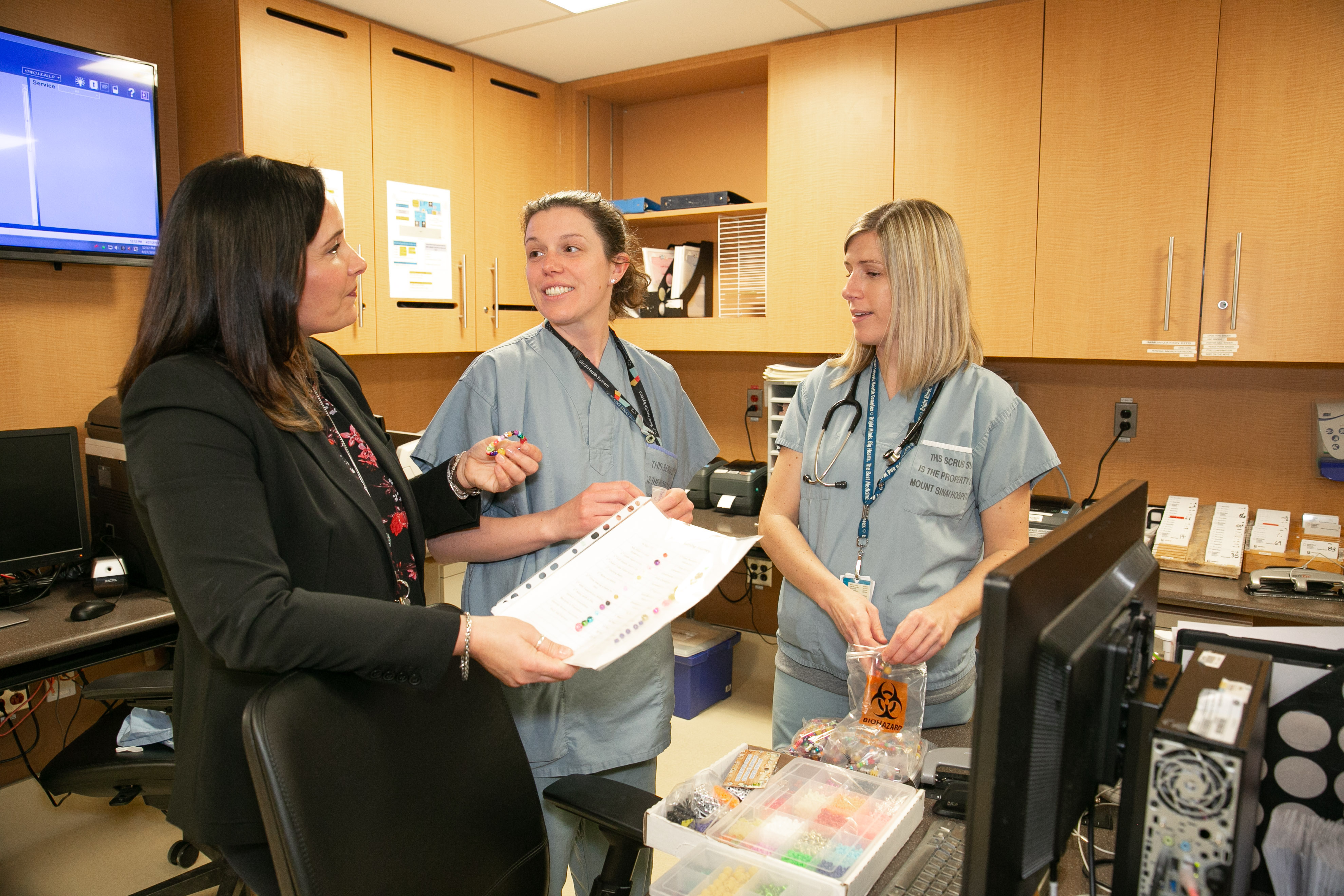 Three nurses on a unit interacting 