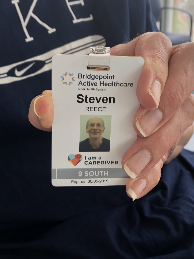 Family caregiver holding new identification badge for Bridgepoint's Family Presence Policy