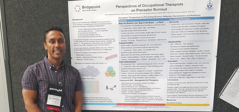 Photo of Occupational Therapist standing in front of his poster at a conference