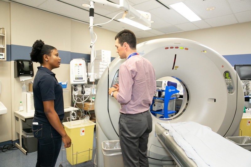 Deborah, a student from Toronto, learns about CT scans from David, Supervisor and Charge Technologist, CT/IR, in the Medical Imaging Department at Mount Sinai