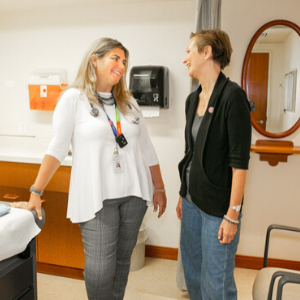 Dr. Christine Brezden-Masley speaks to patient Suzanne in an exam room